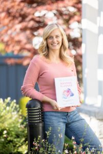 Picture of Author Emily Madill with Seasonal Planner - A Heart-Centered Feminine Approach to Organizing Your Time 